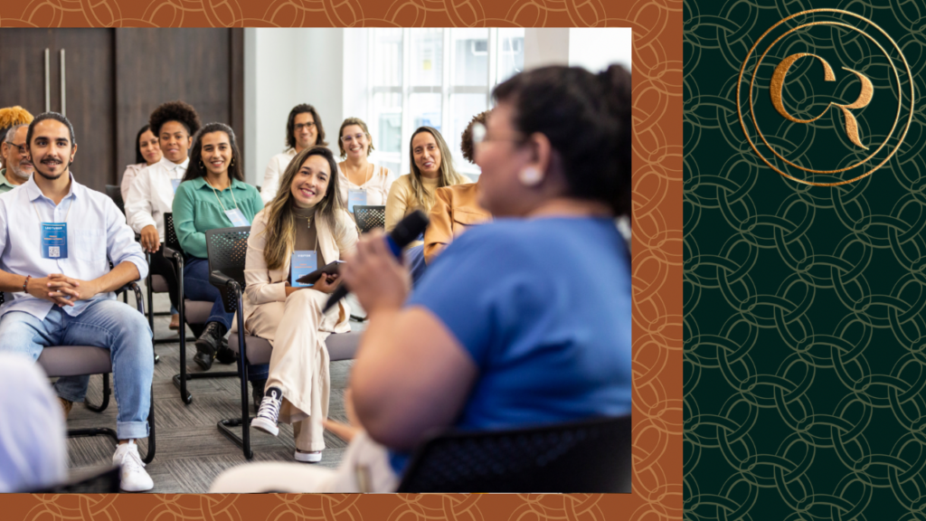 black woman in blue shirt delivering a company workshop to employees in a classroom