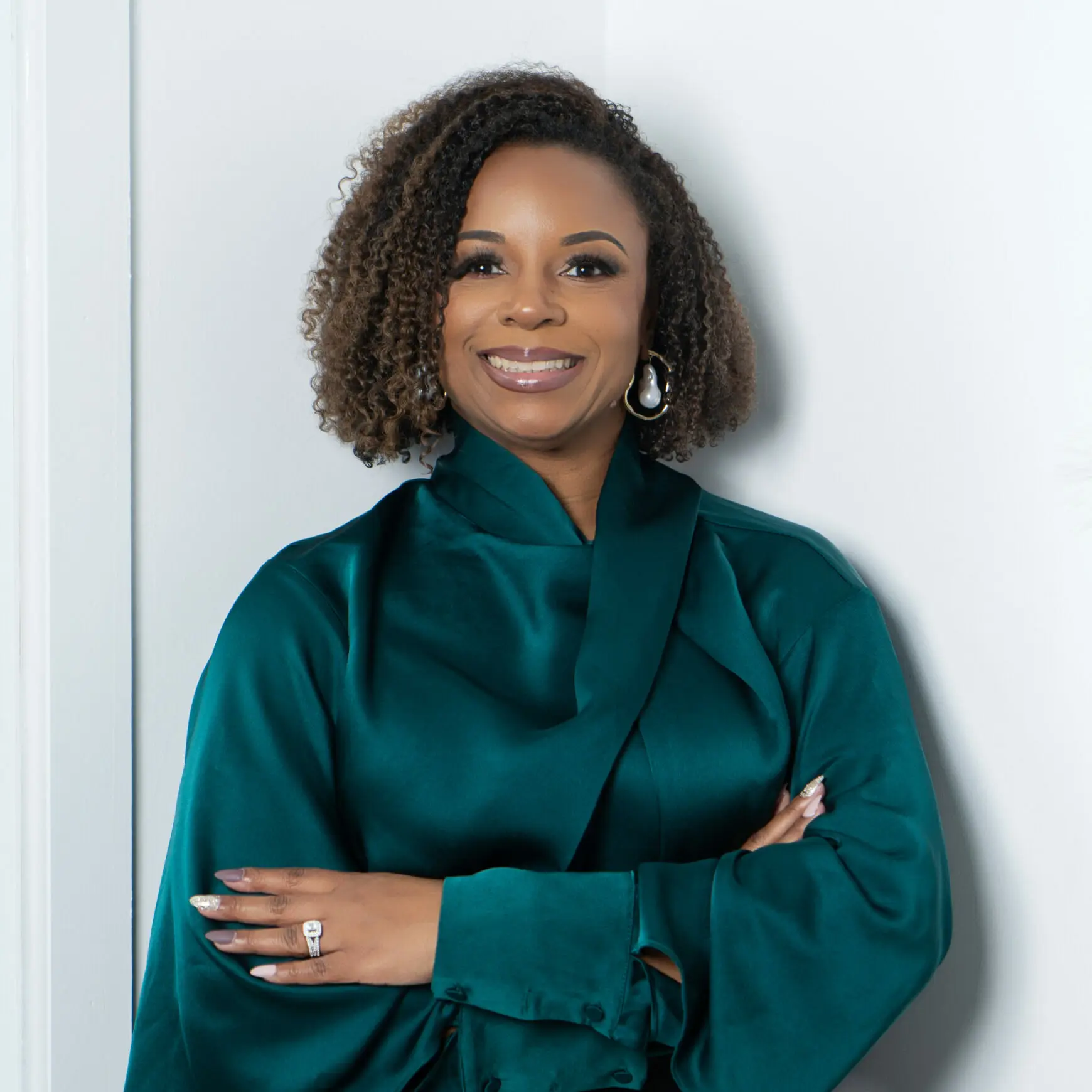 Black woman, natural hair, green shirt, smiling, joyous